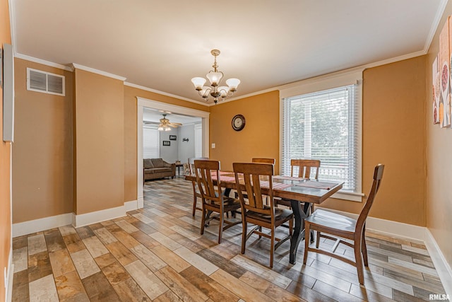dining room with visible vents, ornamental molding, baseboards, and light wood-style floors