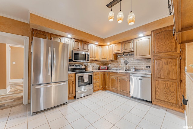 kitchen featuring appliances with stainless steel finishes, a sink, light countertops, tasteful backsplash, and ornamental molding
