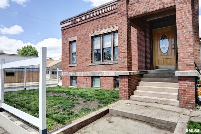 629 W Adams St, Taylorville, IL 62568 - view of exterior entry with brick siding and a yard