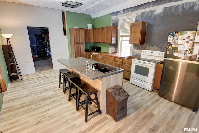 629 W Adams St, Taylorville, IL 62568 - kitchen featuring freestanding refrigerator, electric stove, a sink, and light wood-style flooring