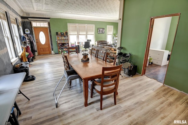 629 W Adams St, Taylorville, IL 62568 - dining room with light wood finished floors, baseboards, crown molding, and an ornate ceiling