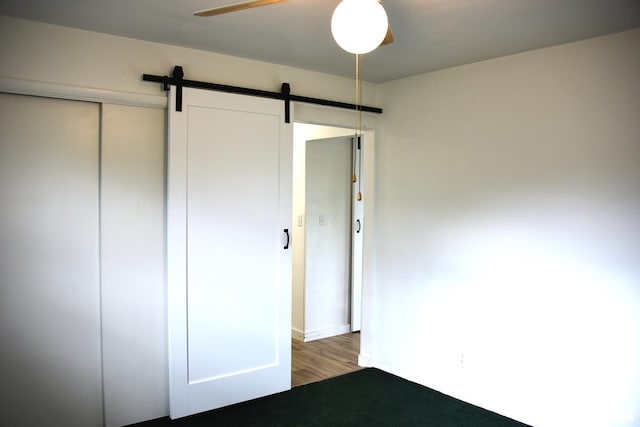 24 Parkway Dr, Sherman, IL 62684 - unfurnished bedroom with a barn door, wood finished floors, and a closet