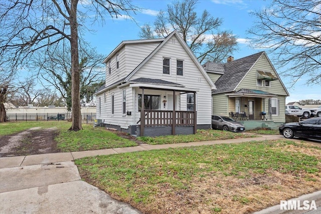 1127 N 6th St, Springfield, IL 62702 - view of front of home with covered porch, fence, and a front lawn