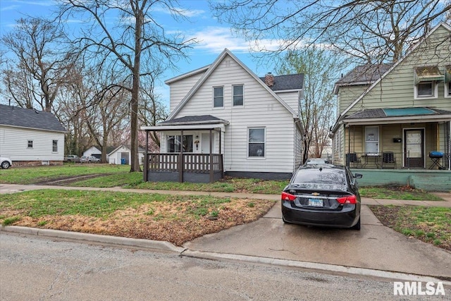 1127 N 6th St, Springfield, IL 62702 - bungalow-style house featuring roof with shingles, covered porch, a chimney, and a front yard