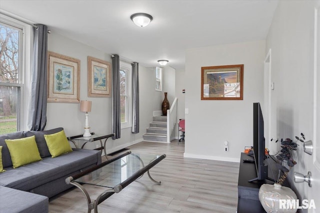 1127 N 6th St, Springfield, IL 62702 - living area featuring baseboards, light wood-style flooring, and stairway