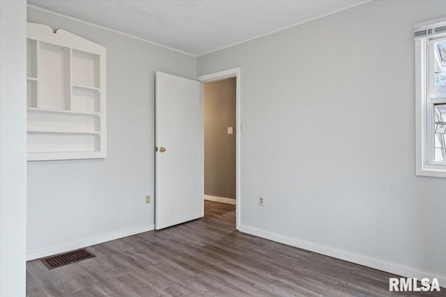 1127 N 6th St, Springfield, IL 62702 - empty room featuring visible vents, wood finished floors, and a wealth of natural light