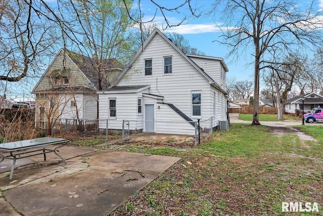 1127 N 6th St, Springfield, IL 62702 - rear view of property with central air condition unit, a yard, and fence