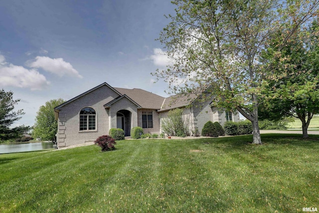 3408 Wynvalley Rd, Quincy, IL 62301 - view of front facade with brick siding, a front yard, and a water view