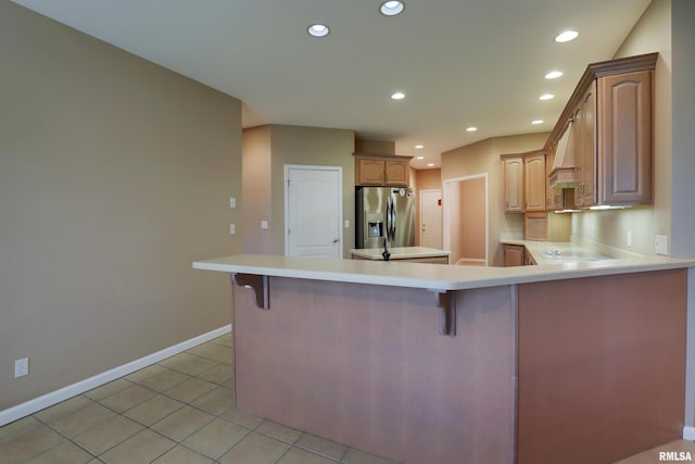 3408 Wynvalley Rd, Quincy, IL 62301 - kitchen featuring stainless steel fridge, a peninsula, light countertops, recessed lighting, and baseboards