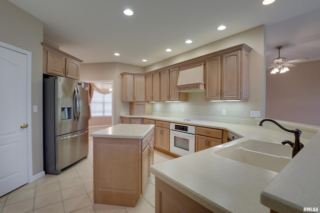 3408 Wynvalley Rd, Quincy, IL 62301 - kitchen featuring white appliances, wall chimney range hood, a sink, light countertops, and a center island