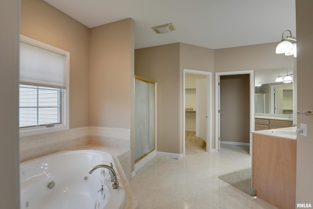3408 Wynvalley Rd, Quincy, IL 62301 - bathroom with a whirlpool tub, a shower stall, vanity, a walk in closet, and tile patterned floors