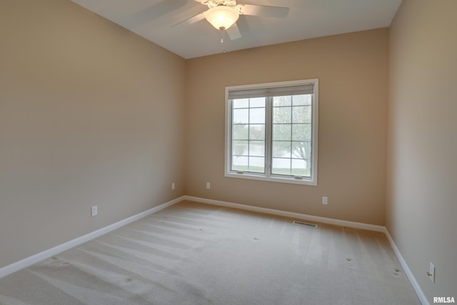 3408 Wynvalley Rd, Quincy, IL 62301 - spare room with light carpet, a ceiling fan, and baseboards