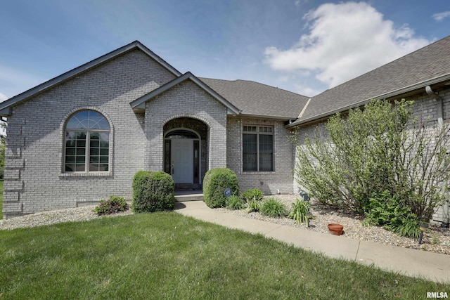 3408 Wynvalley Rd, Quincy, IL 62301 - french country inspired facade featuring brick siding, a front lawn, and a shingled roof