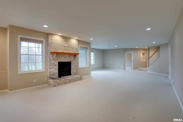 3408 Wynvalley Rd, Quincy, IL 62301 - unfurnished living room with baseboards, a brick fireplace, carpet, stairs, and recessed lighting