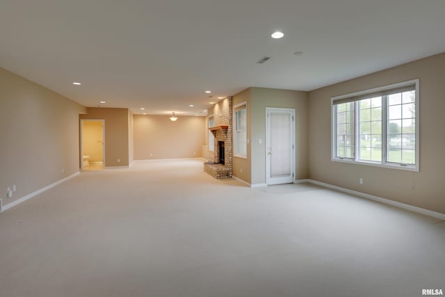3408 Wynvalley Rd, Quincy, IL 62301 - unfurnished living room featuring light carpet, baseboards, recessed lighting, and a fireplace