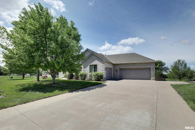 3408 Wynvalley Rd, Quincy, IL 62301 - view of front of property with concrete driveway, a garage, brick siding, and a front lawn