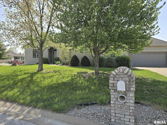 3408 Wynvalley Rd, Quincy, IL 62301 - view of property hidden behind natural elements with concrete driveway and a front lawn