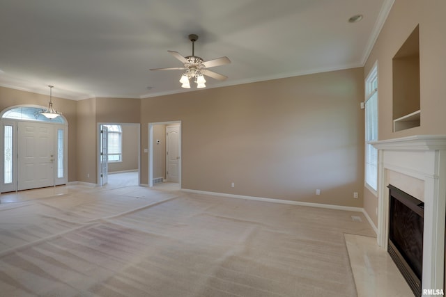 3408 Wynvalley Rd, Quincy, IL 62301 - unfurnished living room with crown molding, ceiling fan, light carpet, a fireplace, and baseboards