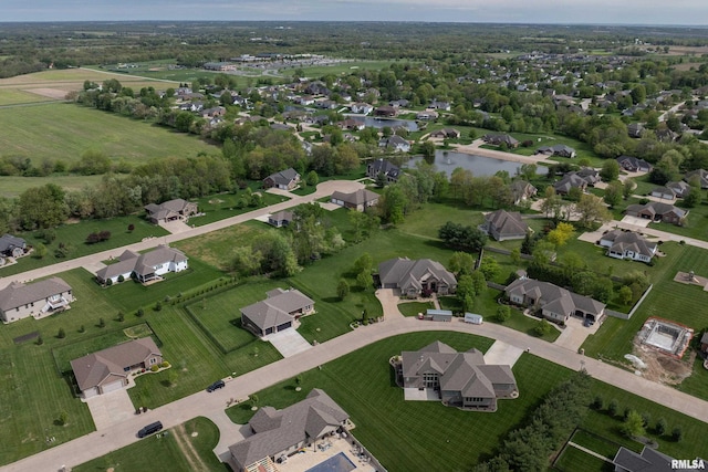 aerial view of property and surrounding area featuring a nearby body of water and nearby suburban area