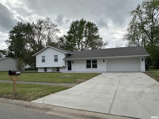 1815 Stonehenge Rd, Springfield, IL 62702 - tri-level home featuring a garage, concrete driveway, brick siding, and a front yard