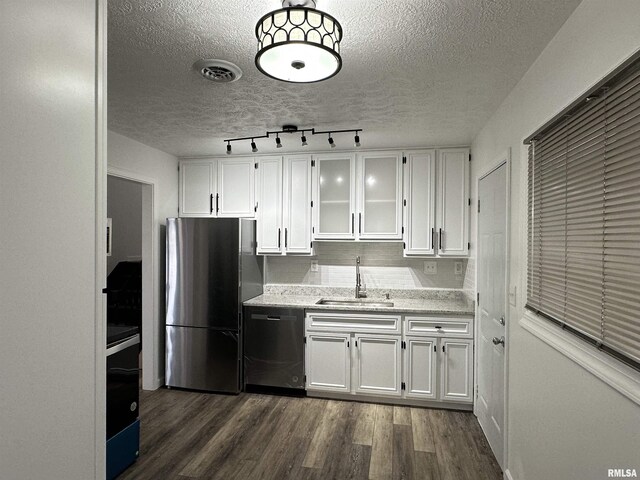 1815 Stonehenge Rd, Springfield, IL 62702 - kitchen featuring appliances with stainless steel finishes, white cabinets, a textured ceiling, dark wood-style flooring, and glass insert cabinets