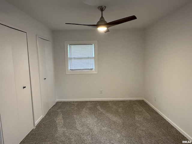 1815 Stonehenge Rd, Springfield, IL 62702 - unfurnished bedroom with two closets, carpet floors, and a ceiling fan