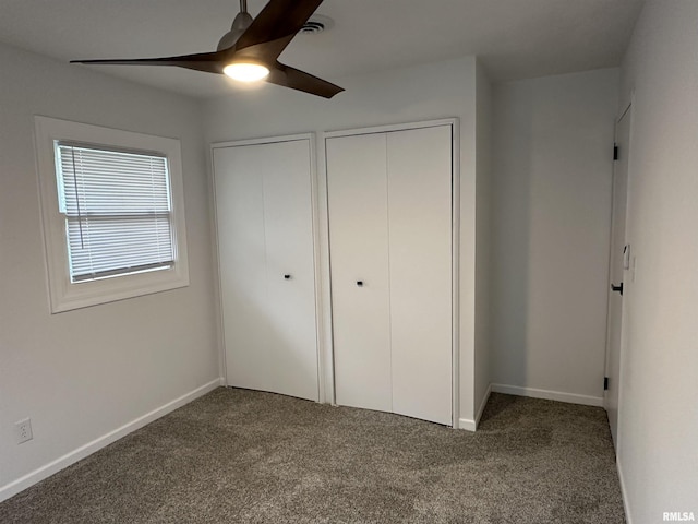 1815 Stonehenge Rd, Springfield, IL 62702 - unfurnished bedroom featuring carpet flooring, two closets, and ceiling fan