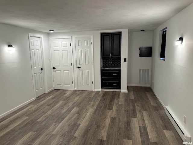 1815 Stonehenge Rd, Springfield, IL 62702 - spare room with baseboard heating and dark wood finished floors