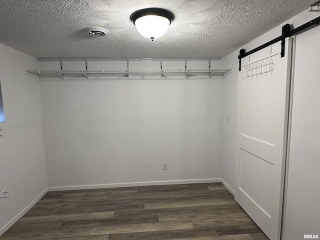 1815 Stonehenge Rd, Springfield, IL 62702 - spacious closet featuring a barn door and dark wood-style floors
