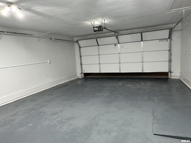 1815 Stonehenge Rd, Springfield, IL 62702 - garage with a garage door opener and baseboards