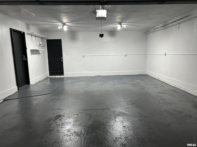 1815 Stonehenge Rd, Springfield, IL 62702 - garage featuring a garage door opener and baseboards