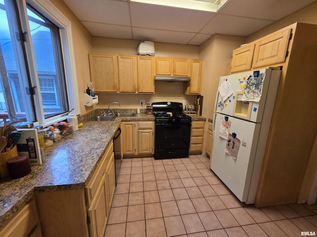 kitchen featuring a sink, light brown cabinets, and black appliances