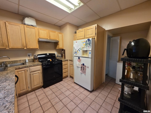 kitchen featuring light brown cabinetry, white refrigerator with ice dispenser, under cabinet range hood, a sink, and gas stove