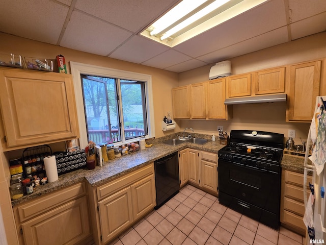 kitchen featuring light brown cabinetry, a sink, a drop ceiling, under cabinet range hood, and black appliances