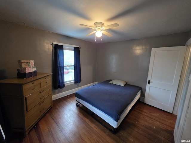 bedroom featuring baseboards, ceiling fan, and dark wood-style floors
