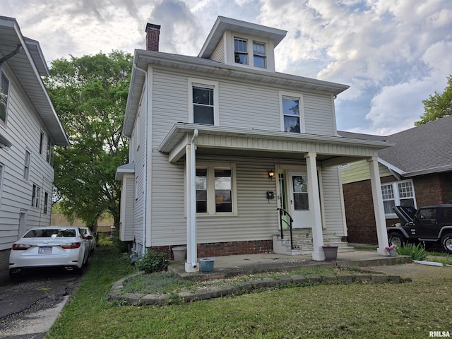 traditional style home featuring a chimney and entry steps