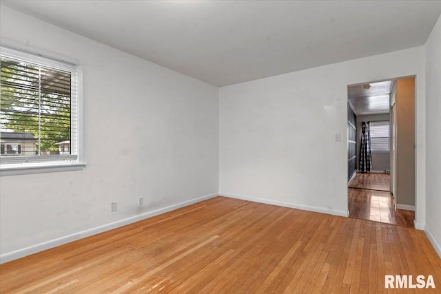 unfurnished room with light wood-style floors and baseboards