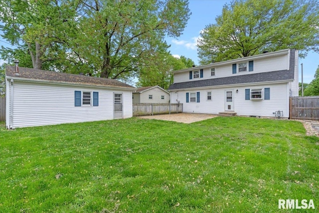 rear view of property featuring entry steps, a yard, a fenced backyard, and a patio area