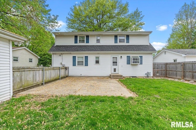 back of house with a patio, a fenced backyard, a shingled roof, entry steps, and a yard