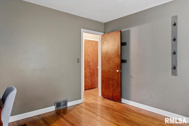 spare room with visible vents, baseboards, and light wood-type flooring