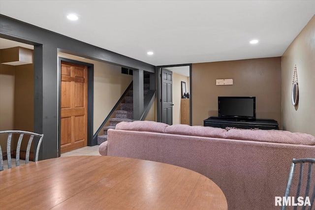 living area featuring recessed lighting, light tile patterned floors, and stairway