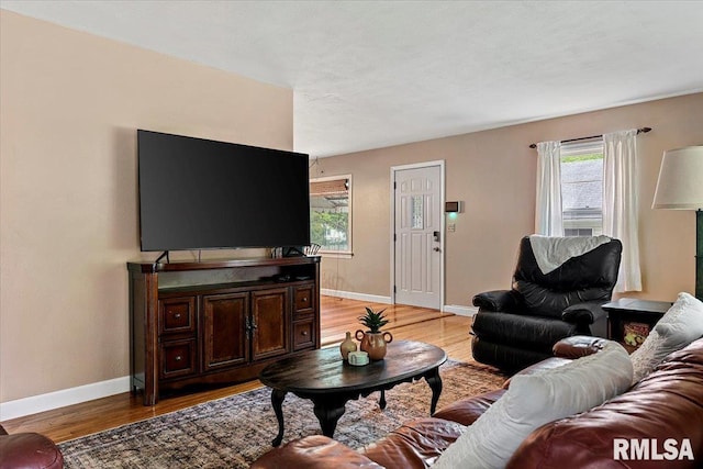 living room featuring light wood-style floors and baseboards