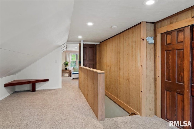 interior space with carpet floors, recessed lighting, an upstairs landing, and lofted ceiling