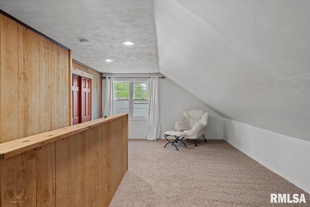 interior space featuring light colored carpet, recessed lighting, baseboards, and lofted ceiling