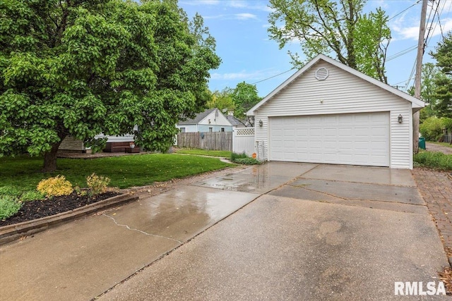 detached garage featuring fence