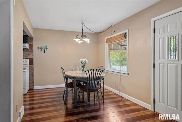 dining room with an inviting chandelier, baseboards, and dark wood finished floors