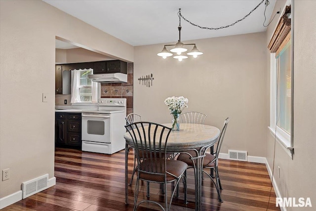 dining space featuring baseboards, dark wood-style floors, and visible vents