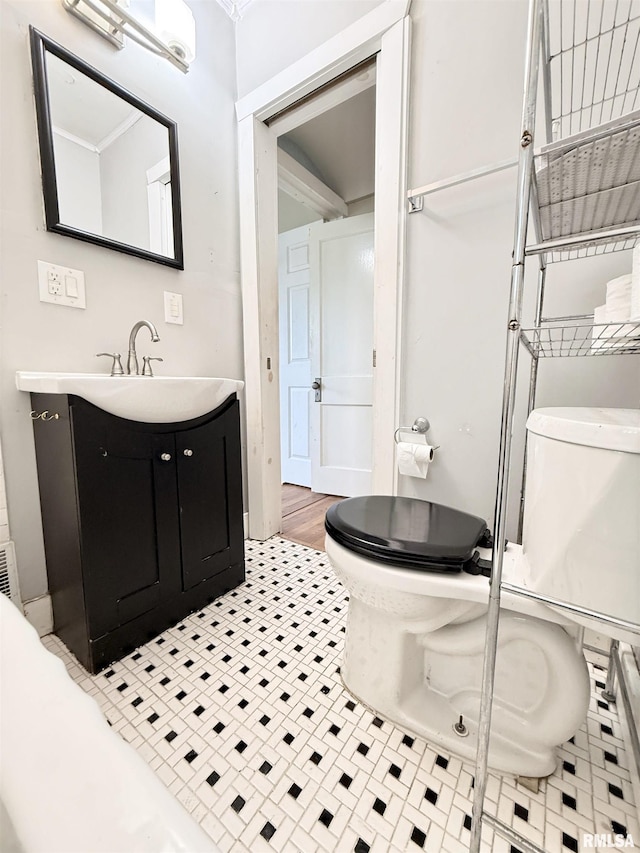 bathroom with toilet and vanity