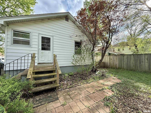 rear view of property featuring fence