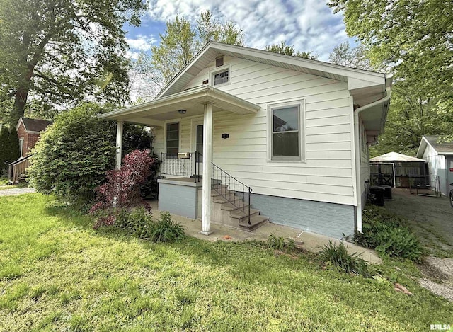bungalow-style home with a front yard
